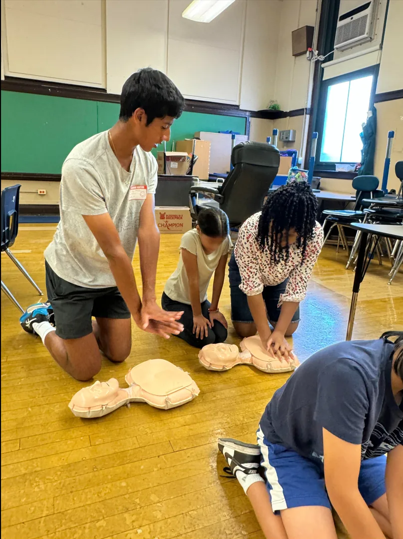 Jay Manadan guiding students through hands-only CPR practice